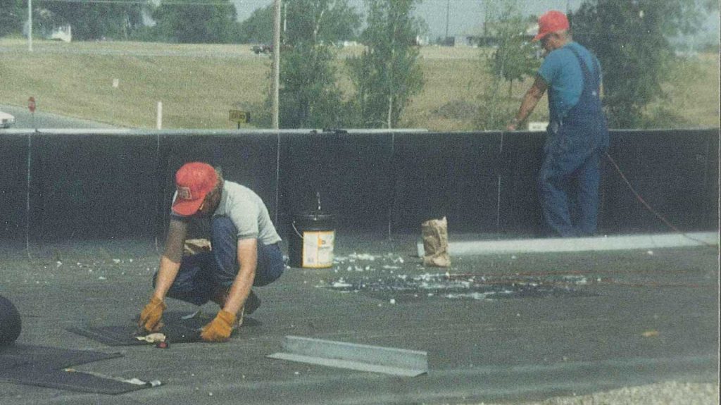 Two men working on roof in 1988