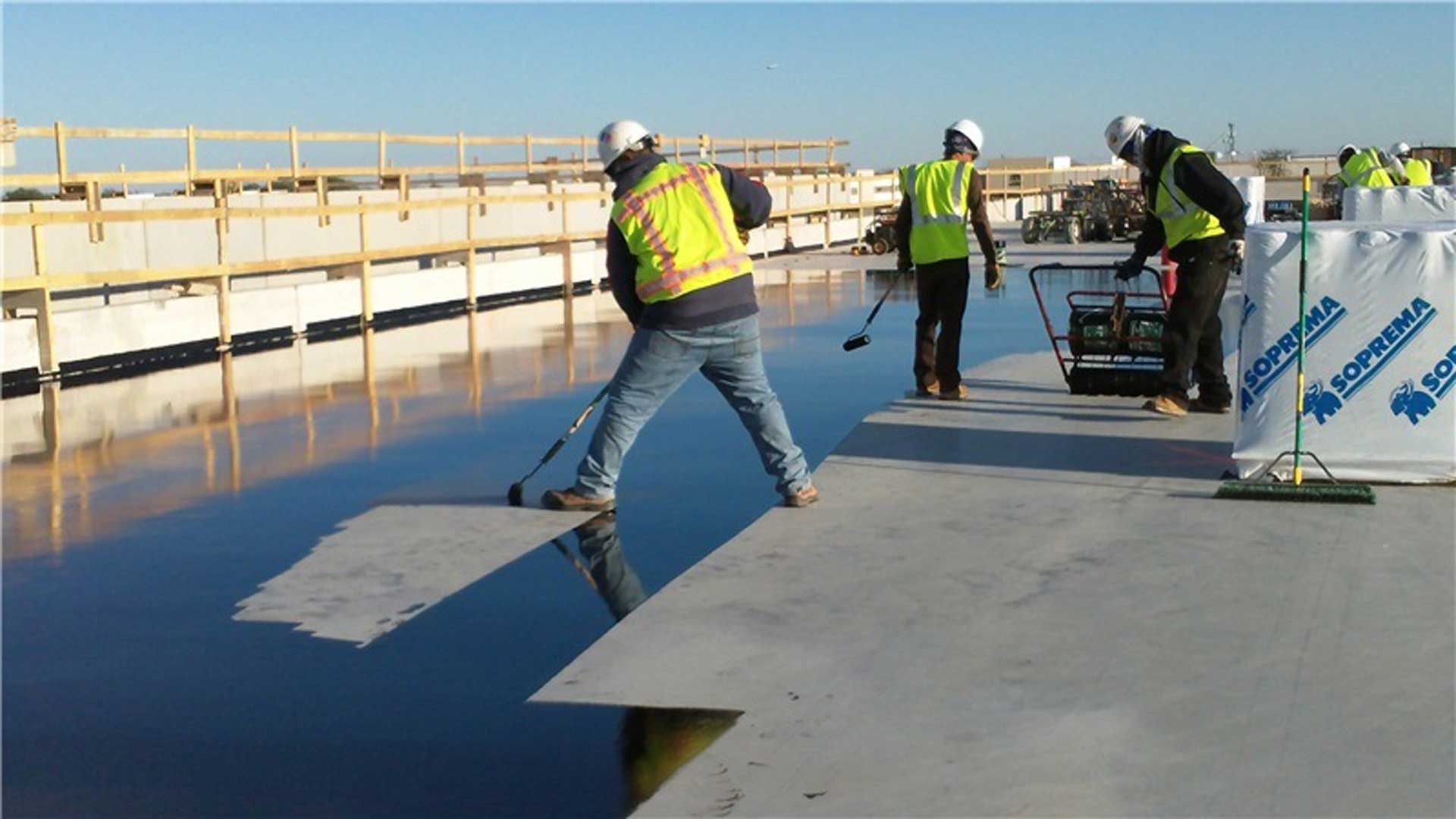 Data-Center-Austin-TX-Men-Applying-Adhesive-to-Roof