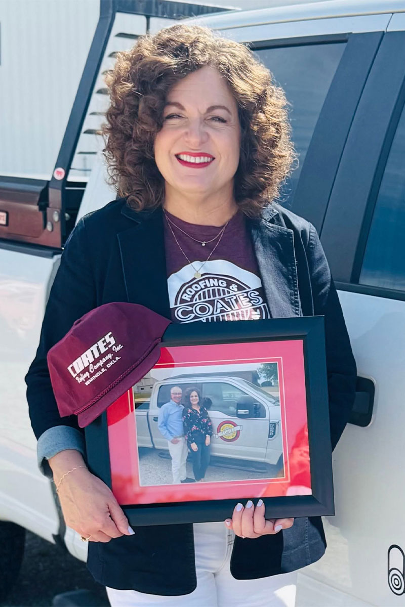 Rhonda-Coates-Standing-Next-to-Coates-Roofing-Truck-with-Framed-Picture-of-Her-and-Brian-Coates Rhonda-Coates-Standing-Next-to-Coates-Roofing-Truck-with-Framed-Picture-of-Her-and-Brian-Coates